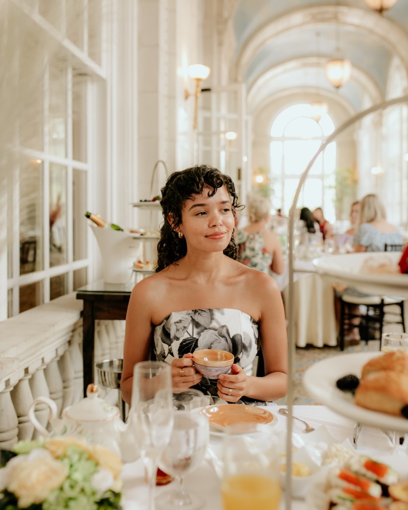 Woman enjoying tea in a fancy dining area