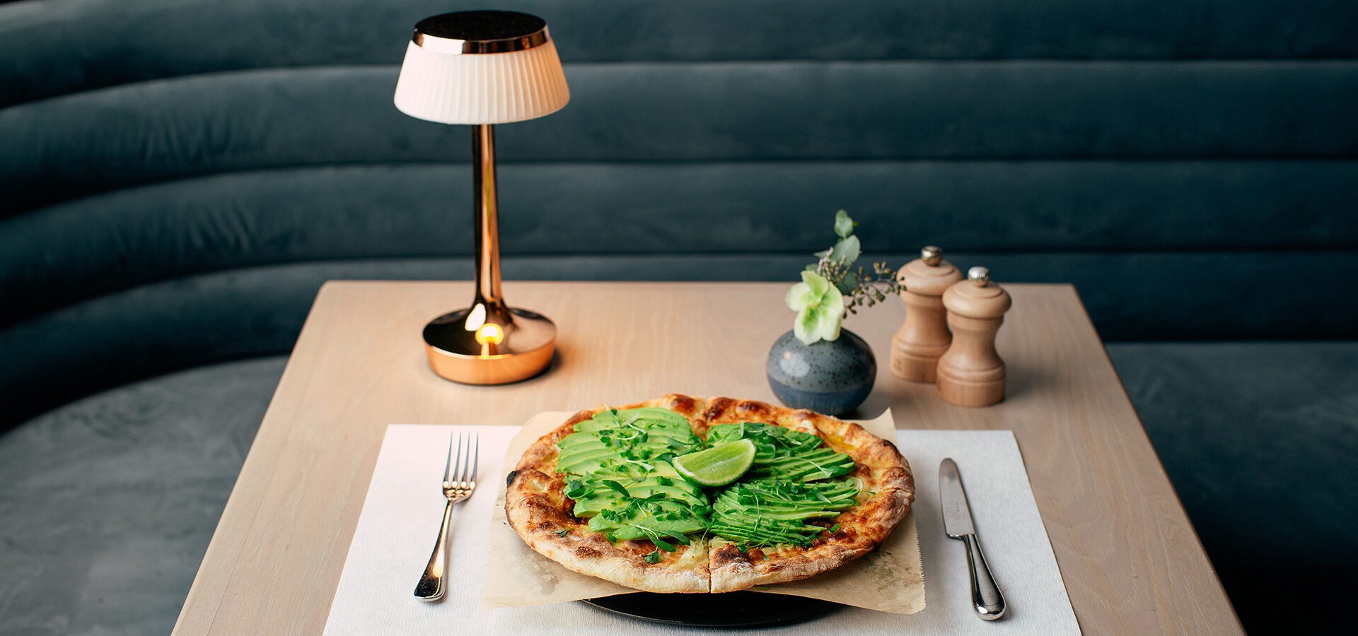 Avocado pizza on table in Druise & Darr