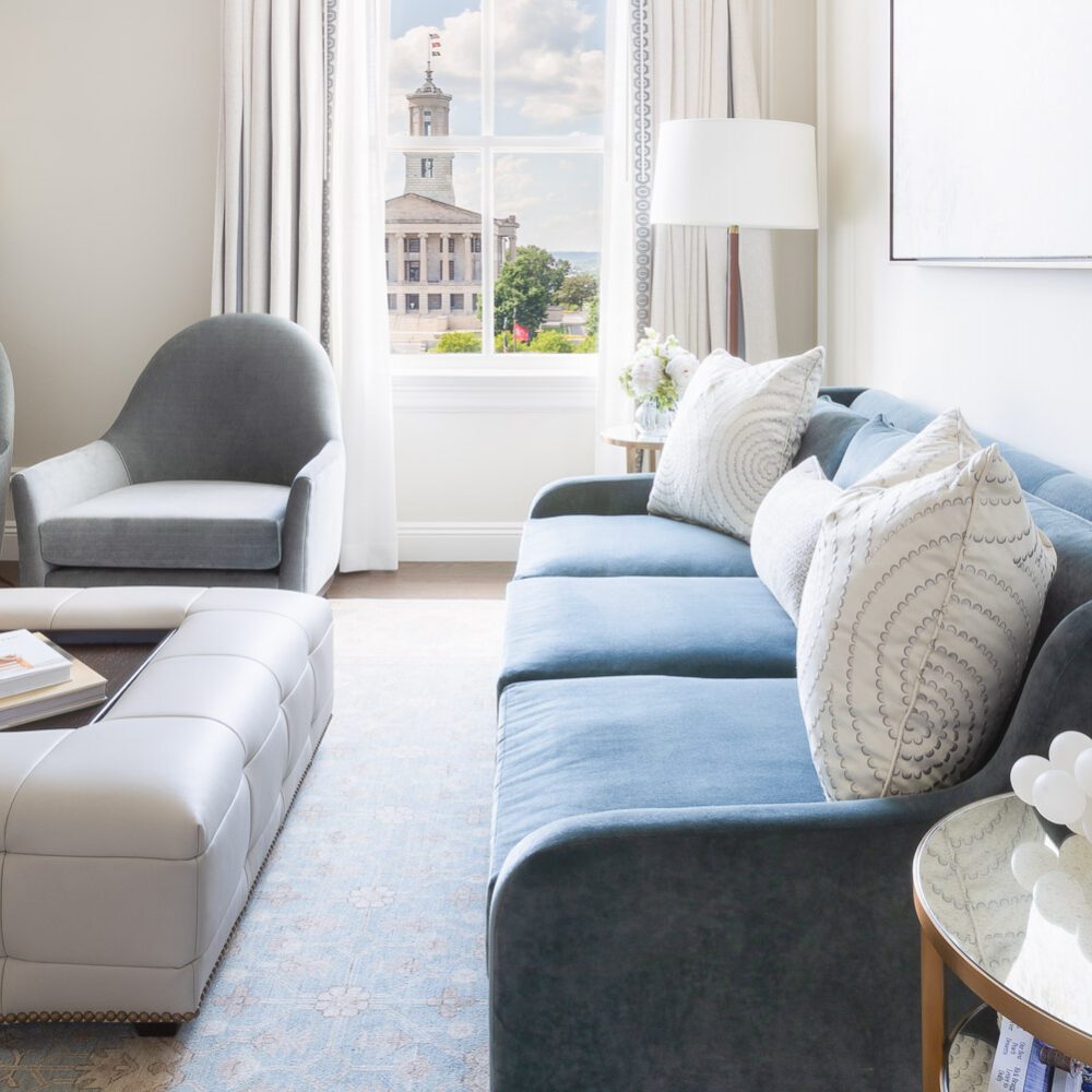 hotel suite with couch and window view