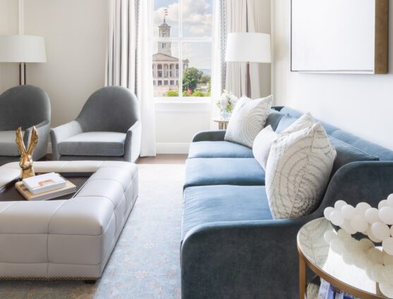 Spacious Hermitage Suite featuring a large sofa, two arm chairs and Nashville city views.