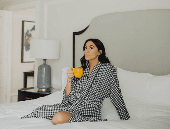 lady sitting on bed with tea